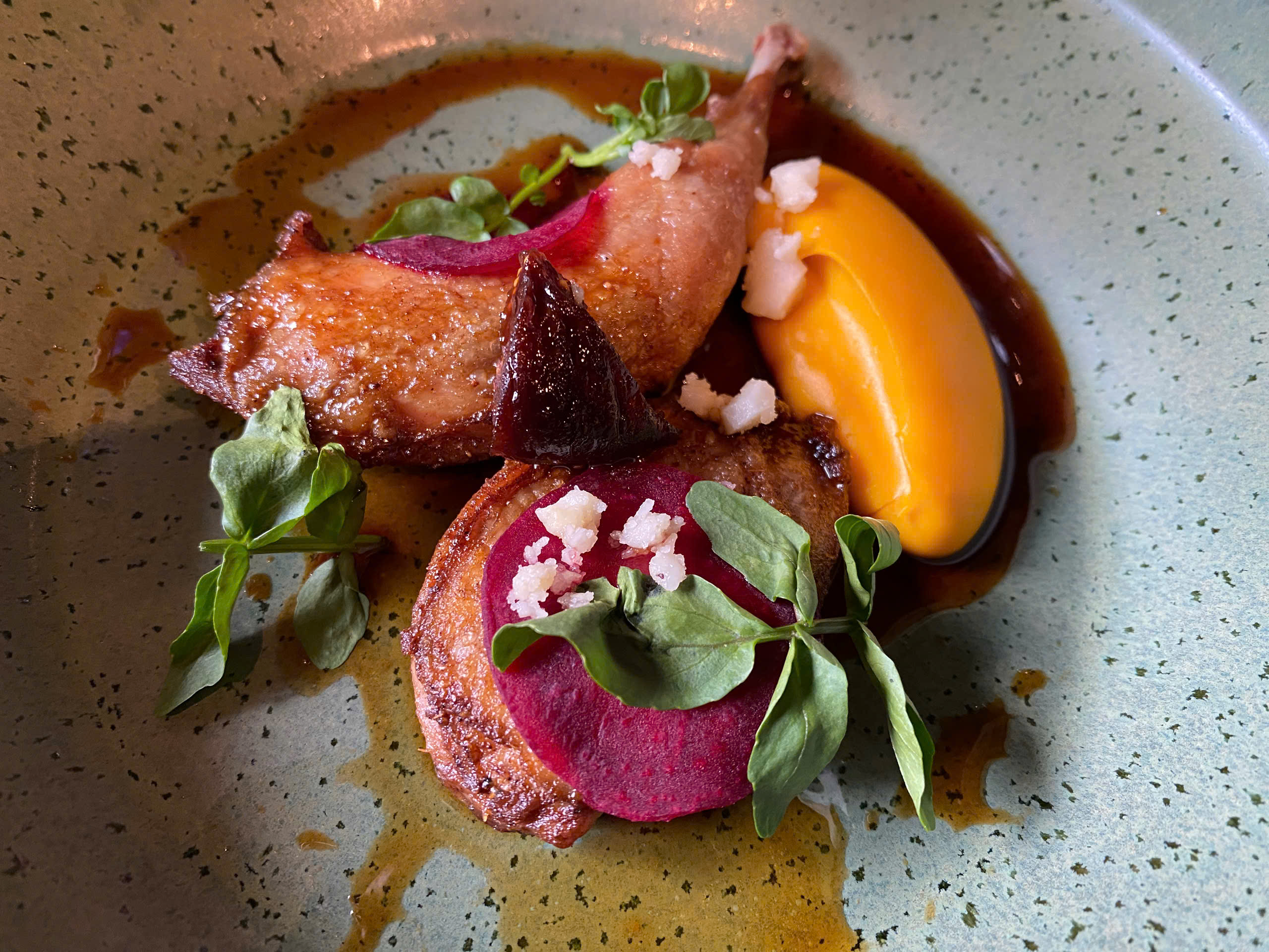 A dish made from Australian quail, a salad of watercress and figs, pumpkin & cream cheese puree, and Vietnamese ginger and pepper jus. Photo: Tran Phuong / Tuoi Tre