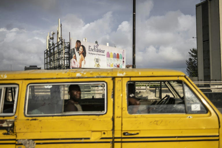 A bus drives past a fragance advertivement on Ring road bridge in Lagos on September 24, 2024. Photo: AFP