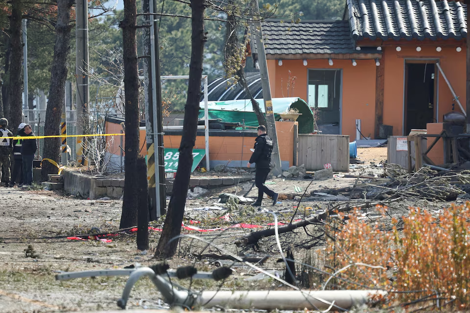 A police officer walks at a cordoned area after South Korea's Air Force said that Mk82 bombs fell from a KF-16 jet outside the shooting range during joint live-fire exercises near the demilitarized zone separating two Koreas in Pocheon, South Korea, March 6, 2025. Photo: Reuters