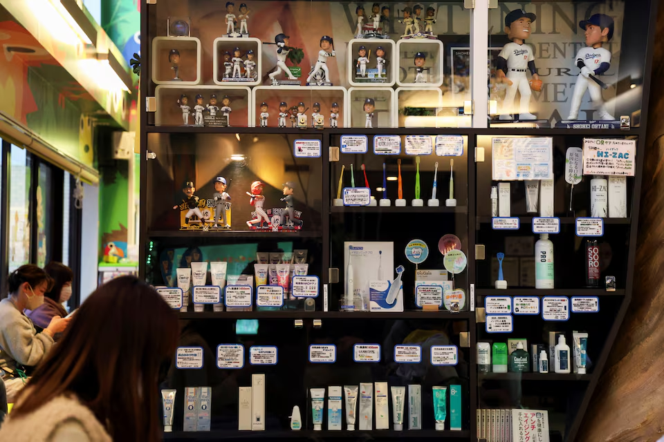 Patients are seen next to the private collections dedicated to Major League Baseball player Shohei Ohtani, at Kamimura dental clinic in Koshigaya, north of Tokyo, Japan February 28, 2025. Photo: Reuters