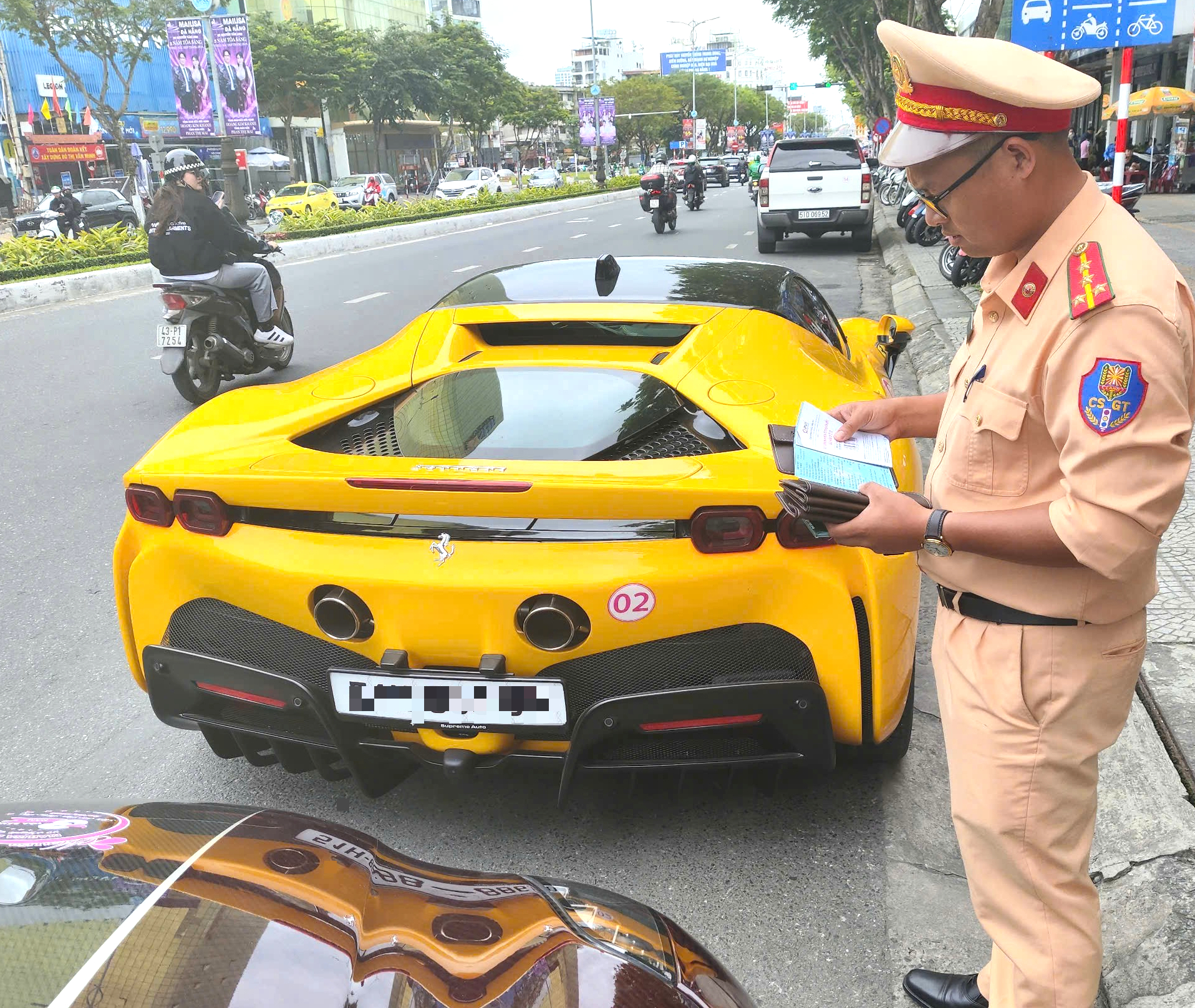 A traffic police officer inspects a supercar from a group that ran a red light at the Nguyen Van Linh-Phan Chau Trinh intersection in Da Nang City, central Vietnam, March 16, 2025. Photo: H.B.