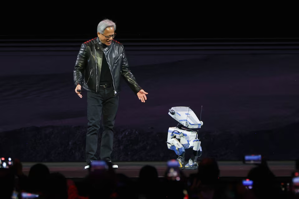 Nvidia CEO Jensen Huang interacts with a small robot on stage during the keynote for the Nvidia GPU Technology Conference (GTC) at the SAP Center in San Jose, California, U.S. March 18, 2025. Photo: Reuters