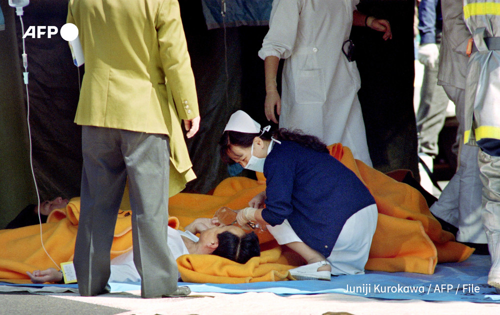 A commuter is treated by an emergency medical team at a make-shift shelter before being transported to hospital after being exposed to Sarin gas fumes in the Tokyo subway system on March 20, 1995 during a Aum sect attack. Photo: AFP