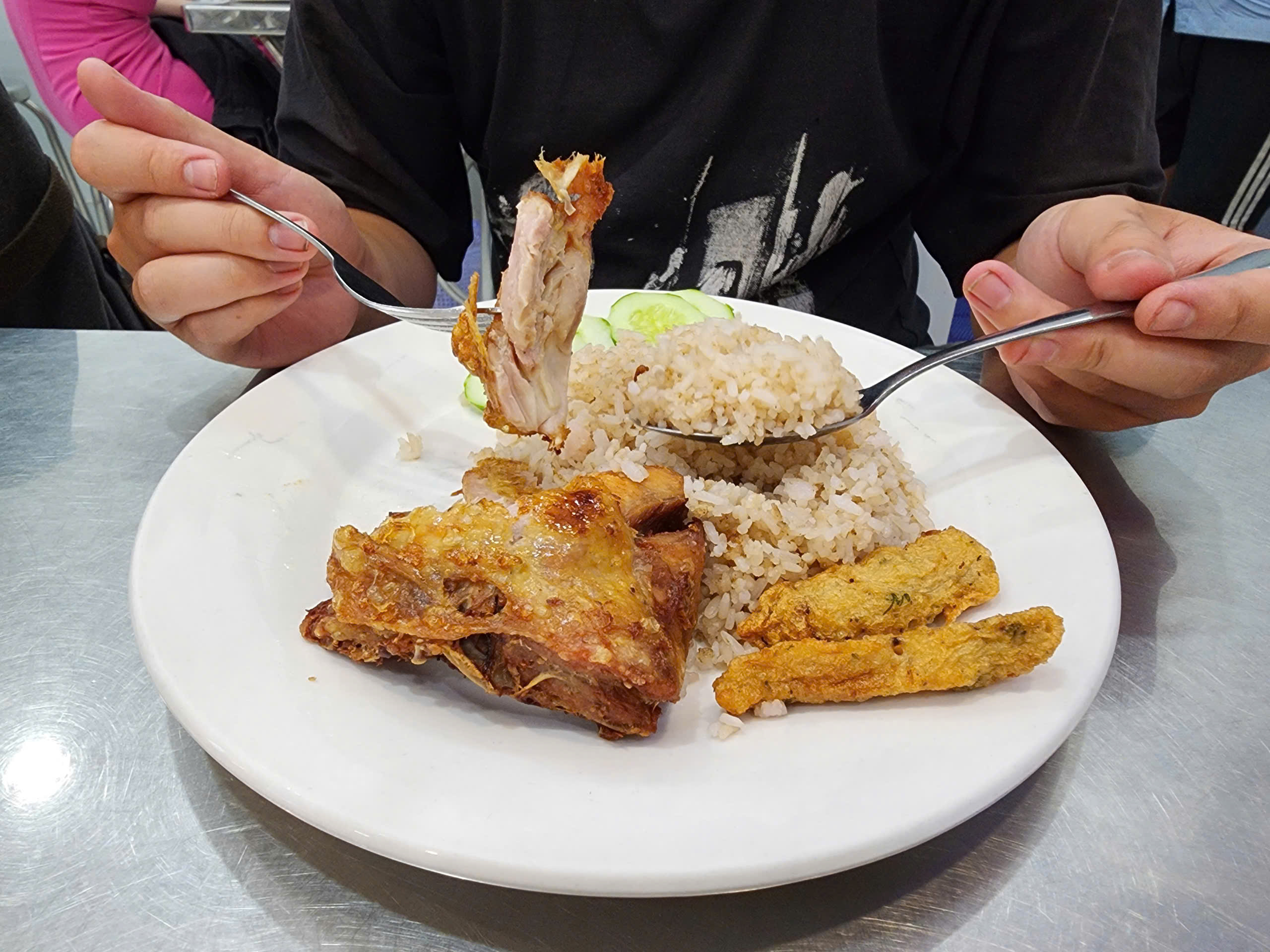 Phat and Hanh’s fried chicken rice is served with fish cakes. Photo: To Cuong / Tuoi Tre