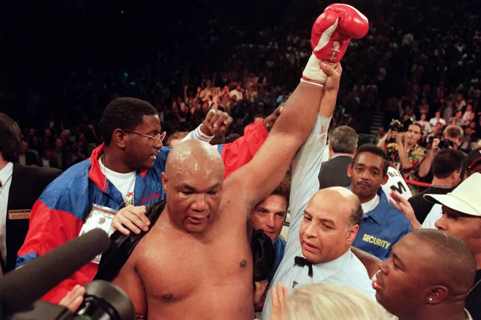 George Foreman raises his arm aloft after defeating Michael Moorer to recapture the heavyweight title in 1994. Photo: AFP