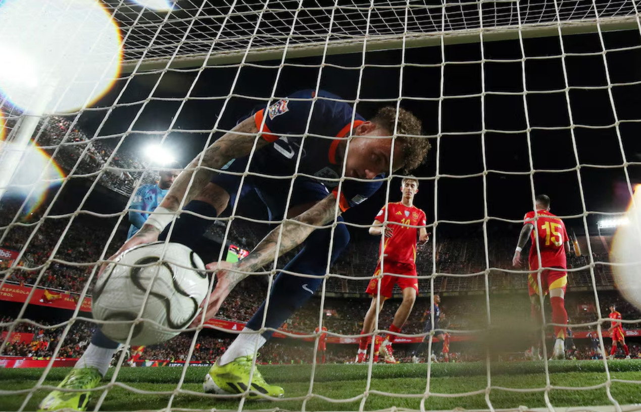 Soccer Football - Nations League - Quarter Final - Second Leg - Spain v Netherlands - Estadio de Mestalla, Valencia, Spain - March 23, 2025 Netherlands' Noa Lang picks the ball up after Xavi Simons scores their third goal from the penalty spot. Photo: Reuters